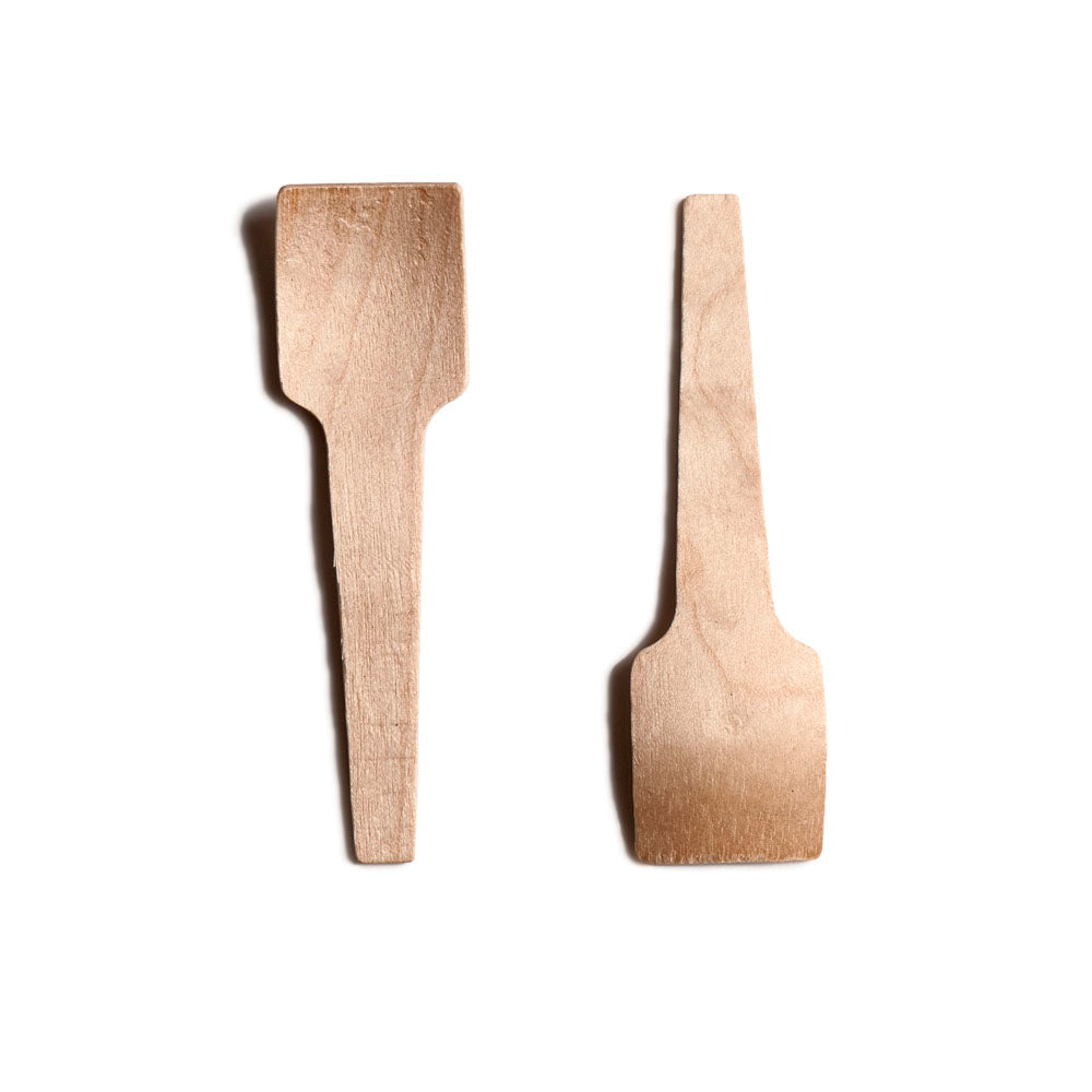 Two wooden spatulas of different shapes and sizes, one with a flat edge and the other with a rounded edge.
