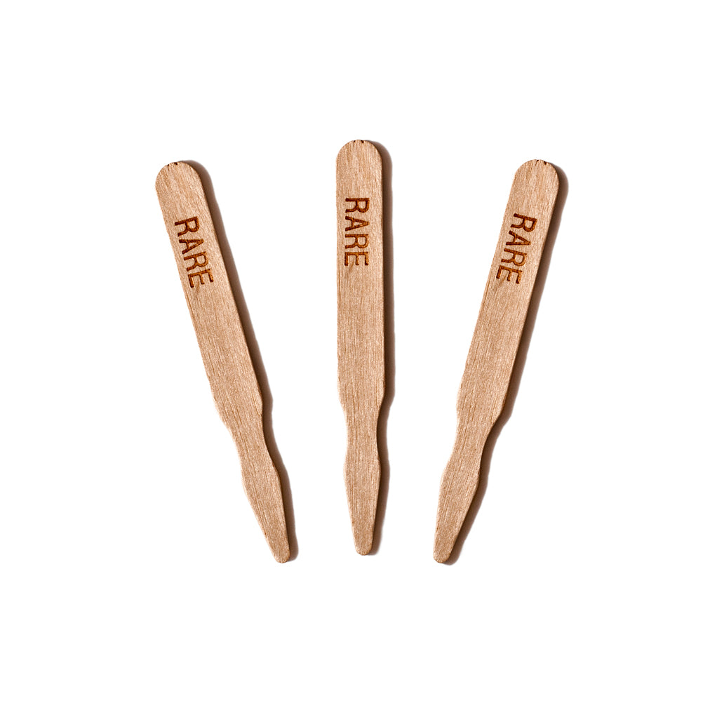 Three wooden meat temperature markers labeled "RARE."