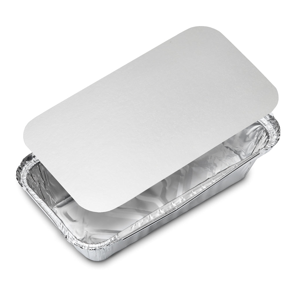 Disposable aluminum foil food container with a plain white paper lid, shown at an angle on a white background; clean, practical packaging.