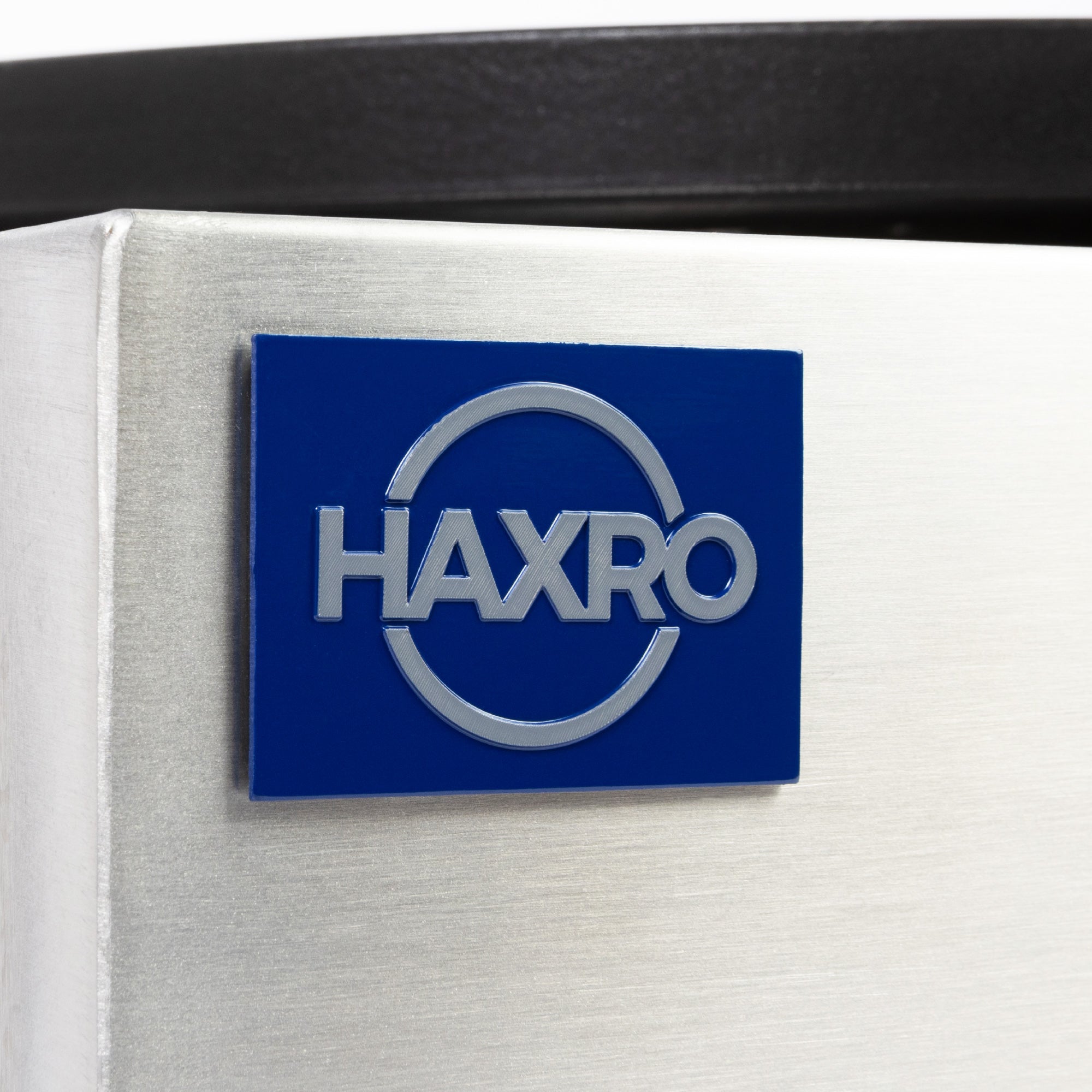 Close-up of the blue Haxro brand logo on the stainless steel body of the crepe maker.