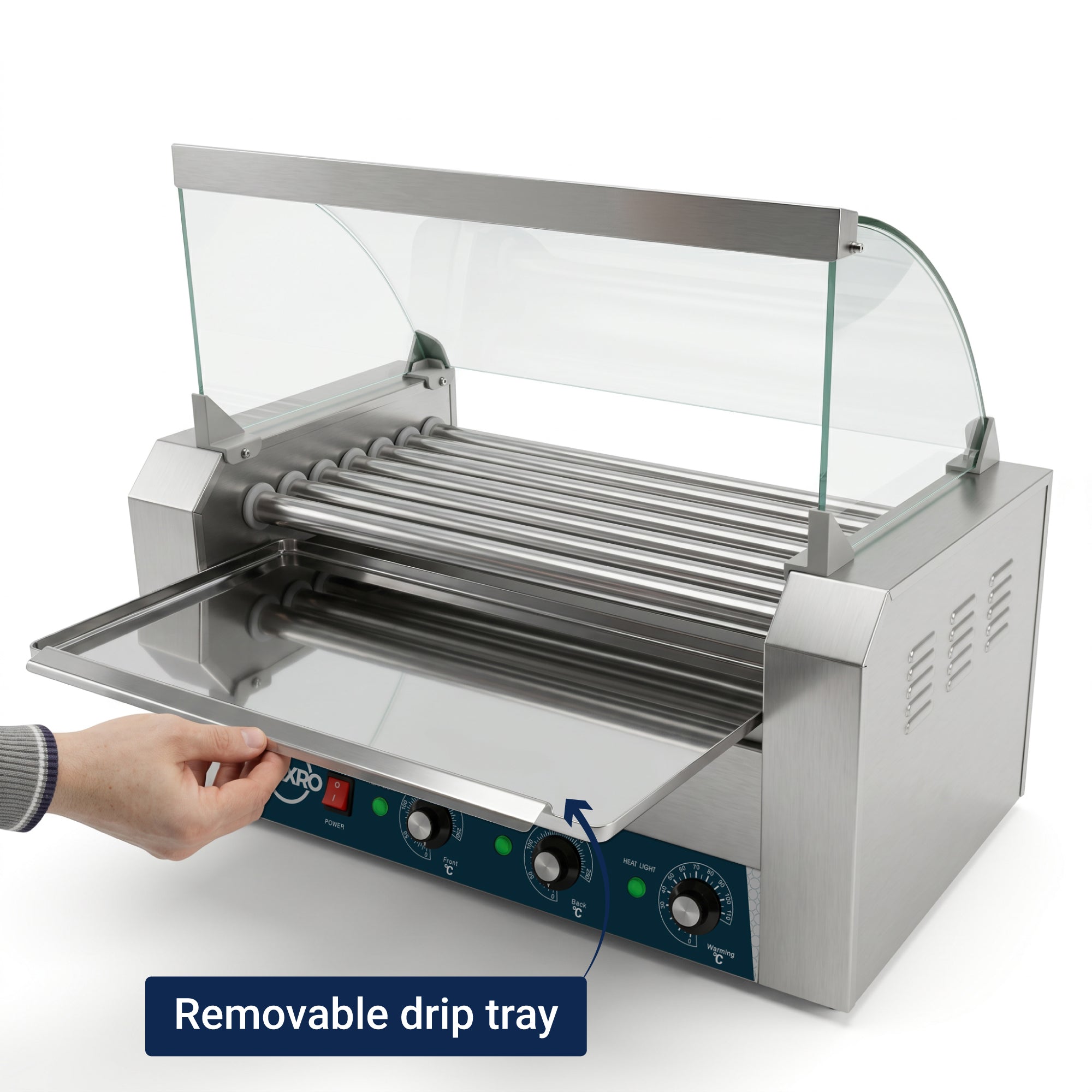 Stainless steel hot dog roller grill with glass canopy. A hand pulls out the removable drip tray. Control knobs and lights are on the front panel.