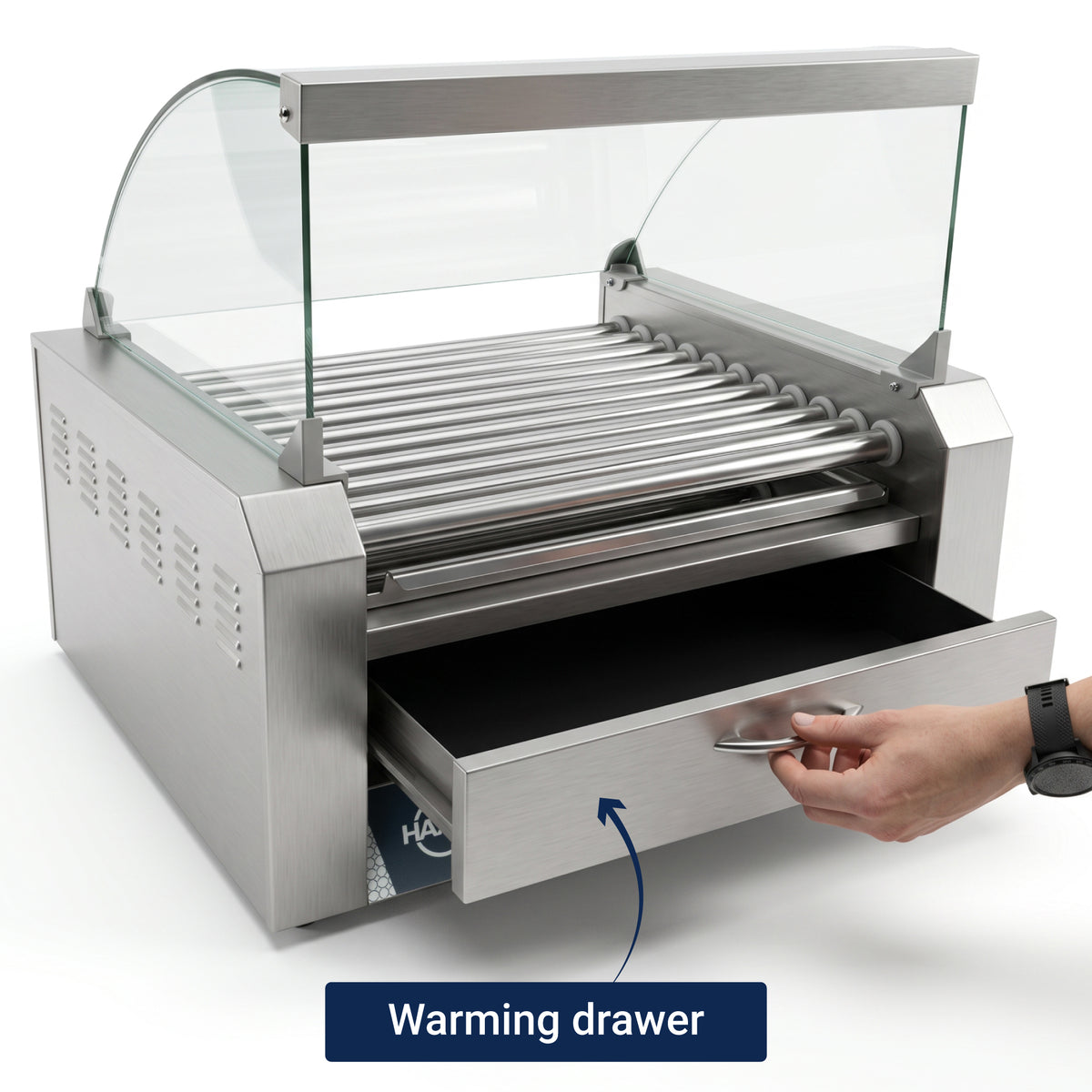 Hand opening the warming drawer of a stainless steel hot dog roller grill with a glass shield.