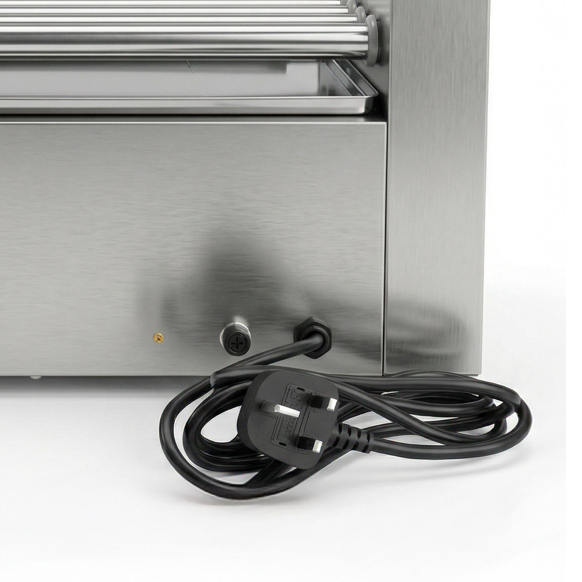 Close-up of a stainless steel appliance with a coiled black power cord and a UK three-prong plug on a white background.