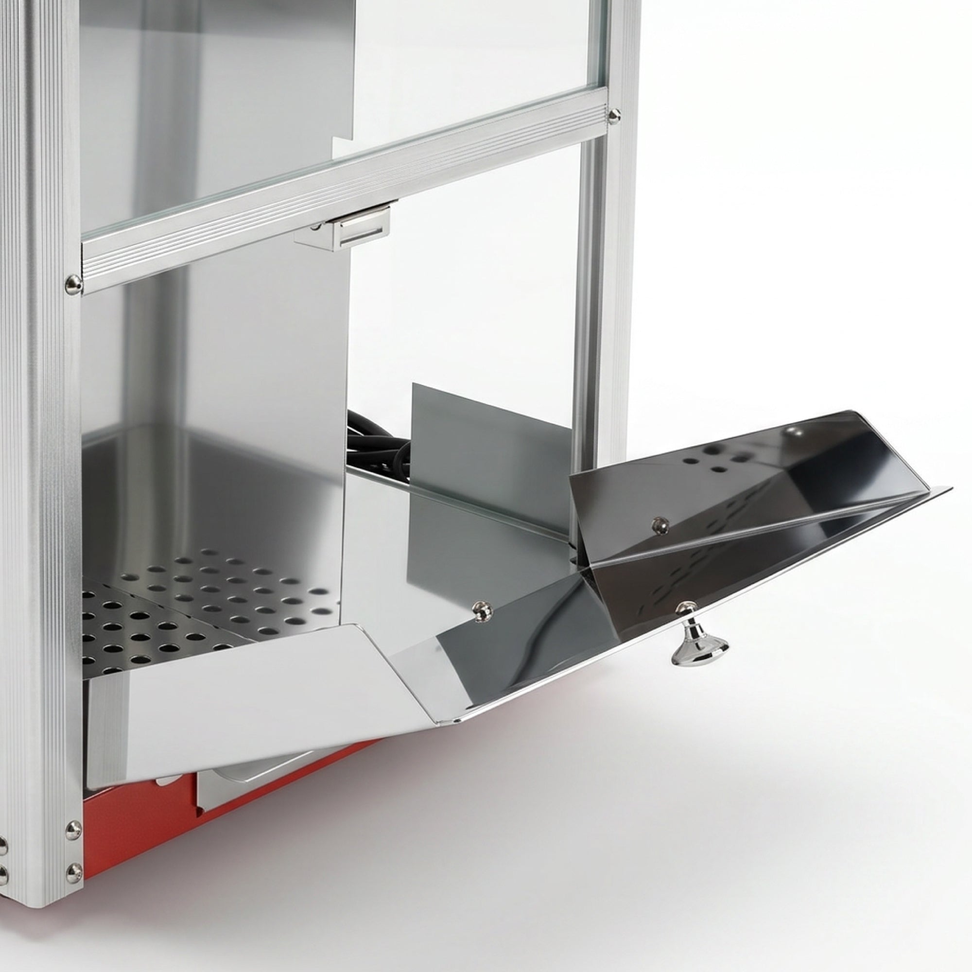 Close-up of a modern, metal popcorn machine with a sleek design. The open, shiny chute contrasts with the perforated interior, suggesting freshness and efficiency.