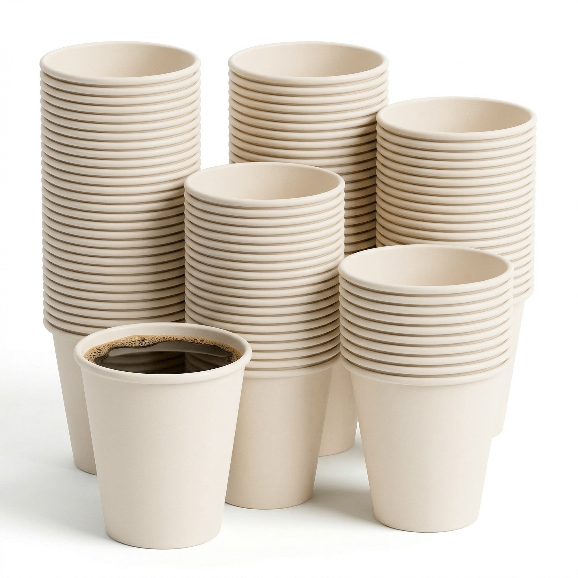 A stack of beige paper cups with one filled with black coffee in the foreground. The arrangement conveys abundance and simplicity.