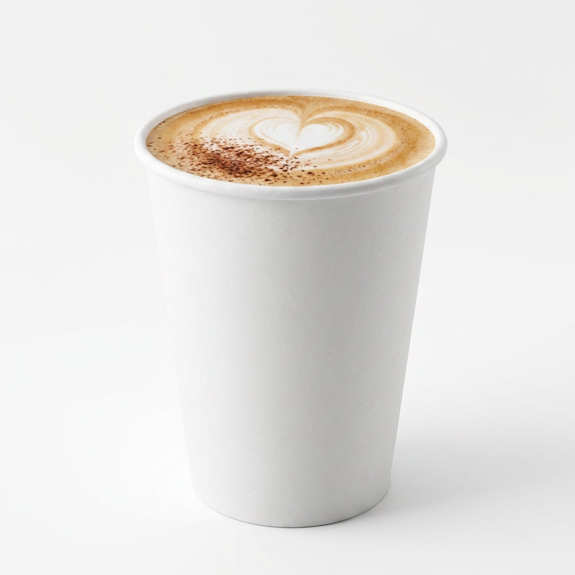 A white paper cup of coffee with a heart-shaped latte art design on top.