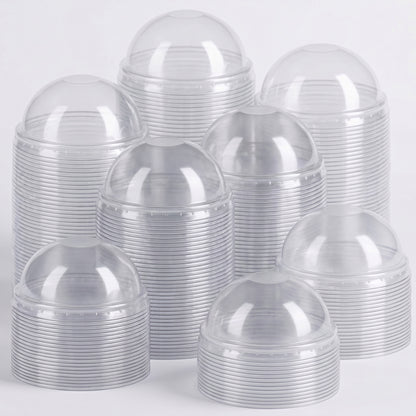 Stacks of clear plastic cups with dome lids are arranged closely together against a white background, conveying a clean, organized appearance.