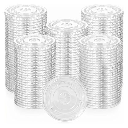 Stacks of transparent plastic lids are arranged in rows against a white background. The lids have a circular design, creating a sense of order.