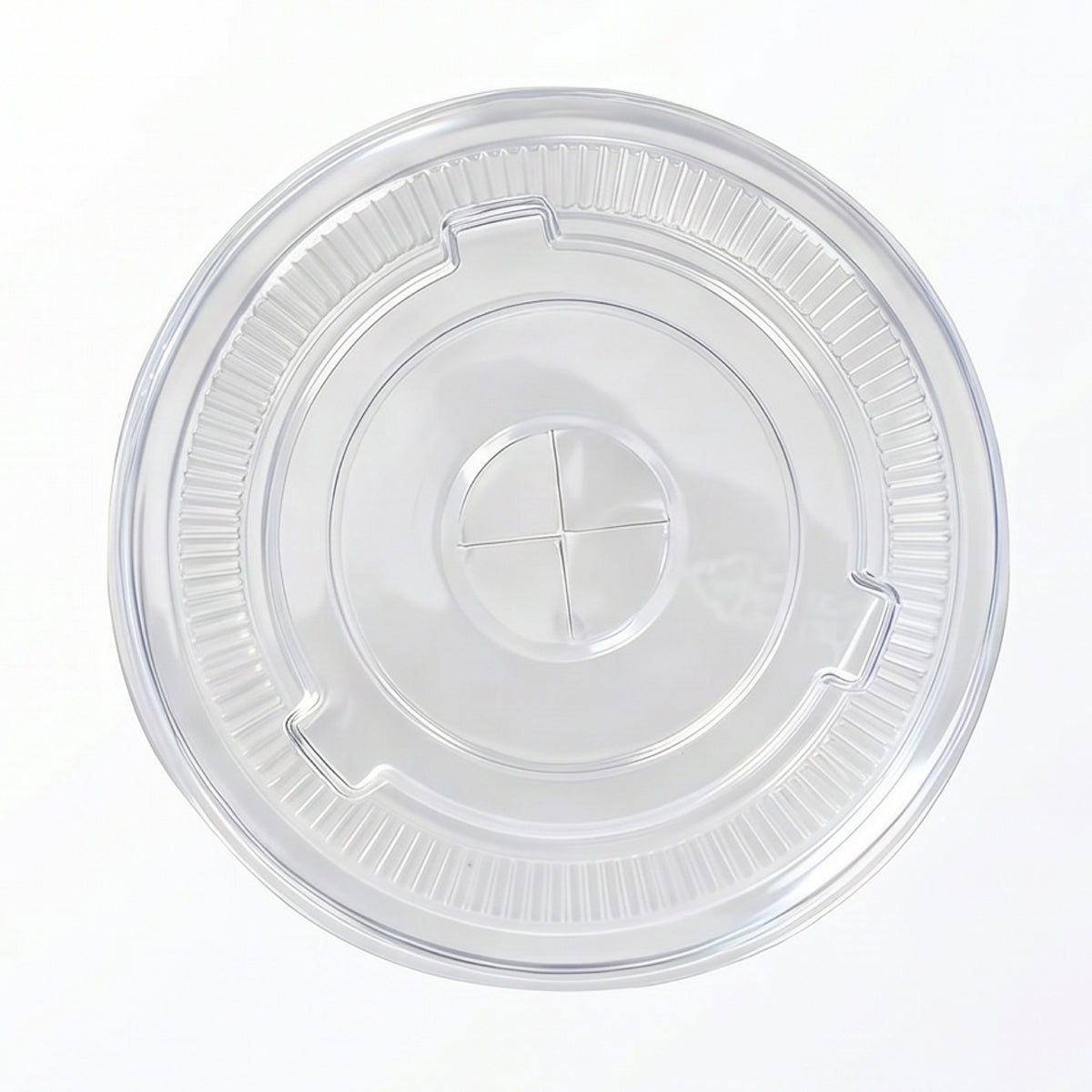A clear, round plastic lid featuring a textured rim and central cross design is shown against a white background, conveying simplicity and functionality.