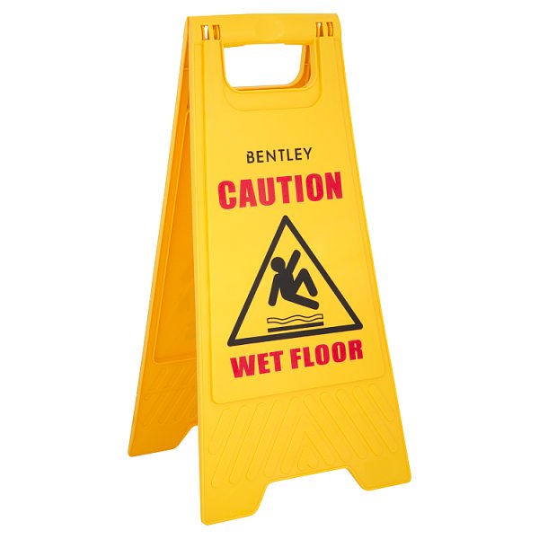 A bright yellow folding Bentley wet-floor sign displays red “CAUTION” and “WET FLOOR” text with a slipping-person symbol, conveying a clear safety warning.