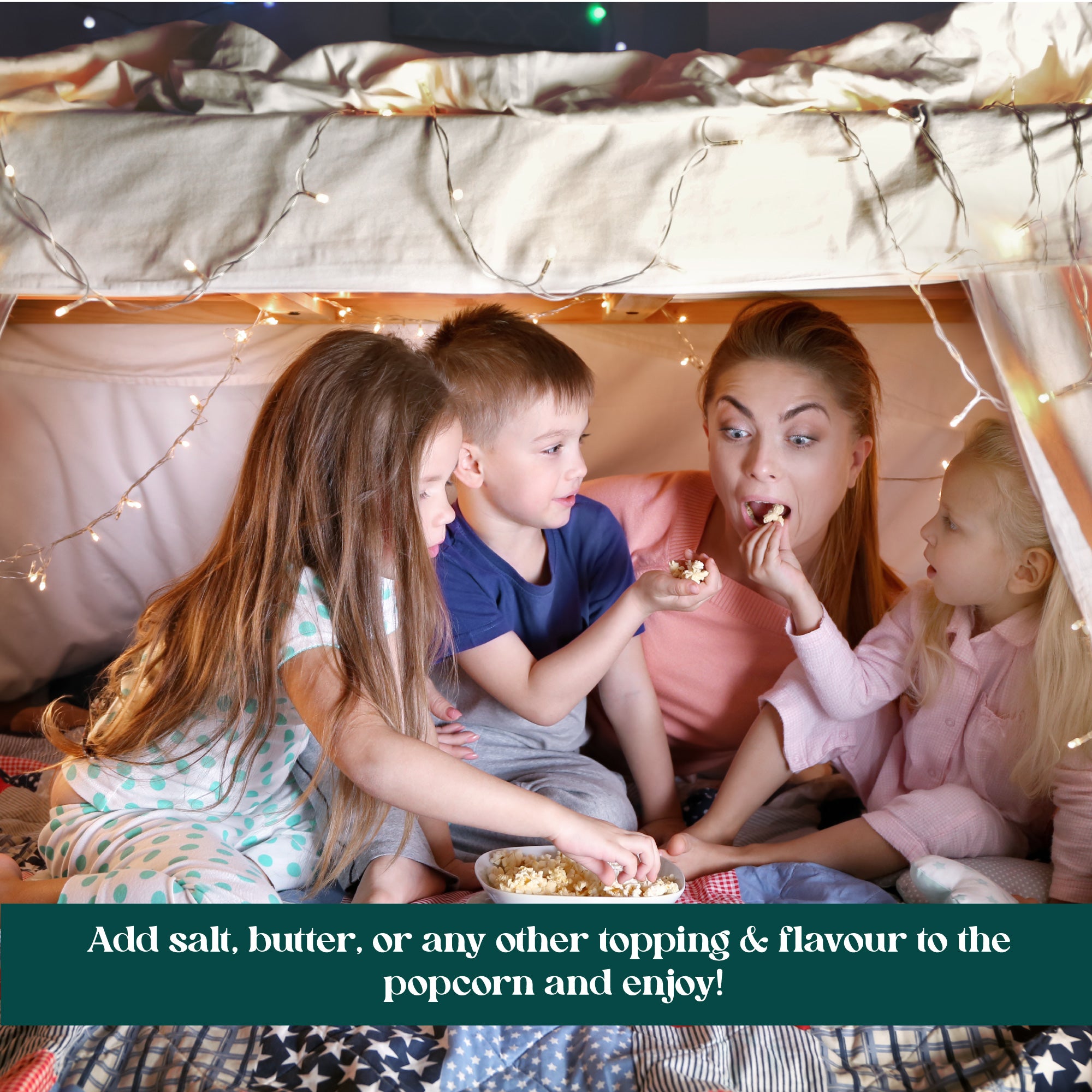 A group of four children sitting inside a tent, sharing popcorn and enjoying each other's company.