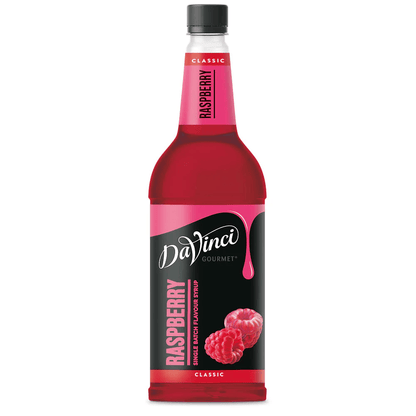 A bottle of DaVinci Gourmet Raspberry syrup with a red liquid and raspberries on the label.