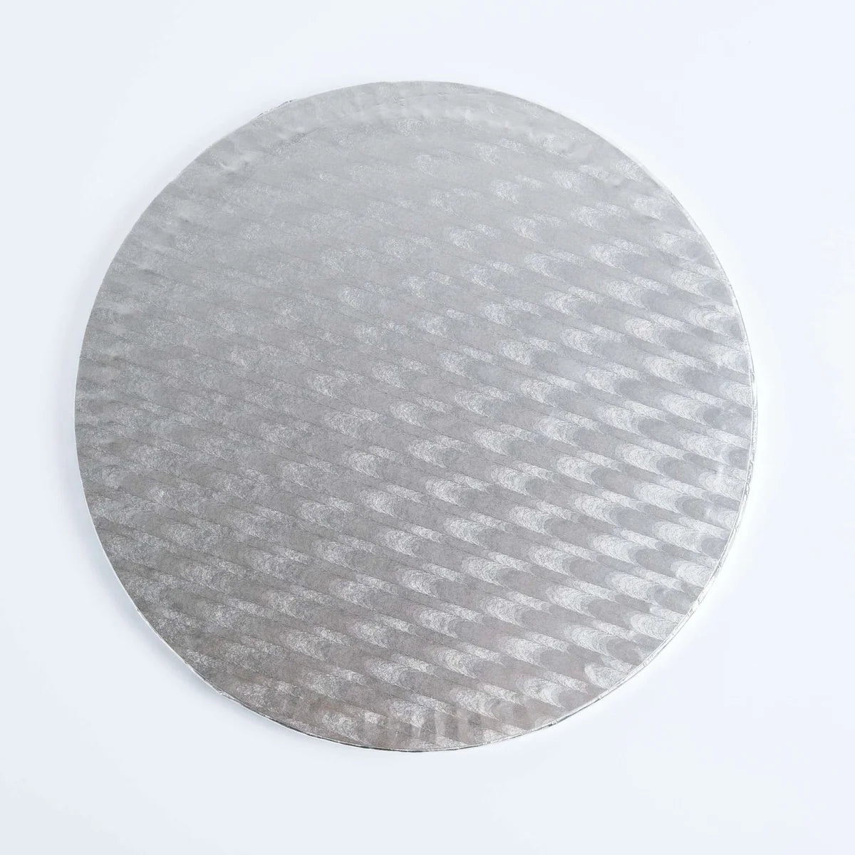 A round silver cake board with a textured, embossed geometric pattern, shown on a clean white background.