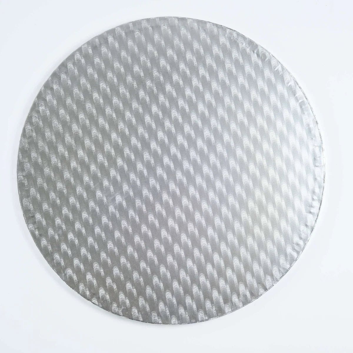 A round silver cake board with a textured, embossed pattern of small arches, shown on a plain white background.