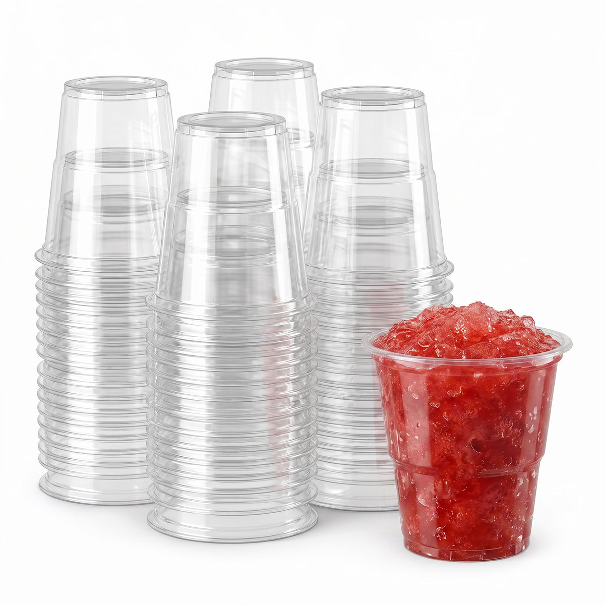 Stacks of clear plastic cups are arranged neatly. In front, a single cup is filled with vibrant red crushed ice, suggesting a refreshing treat.
