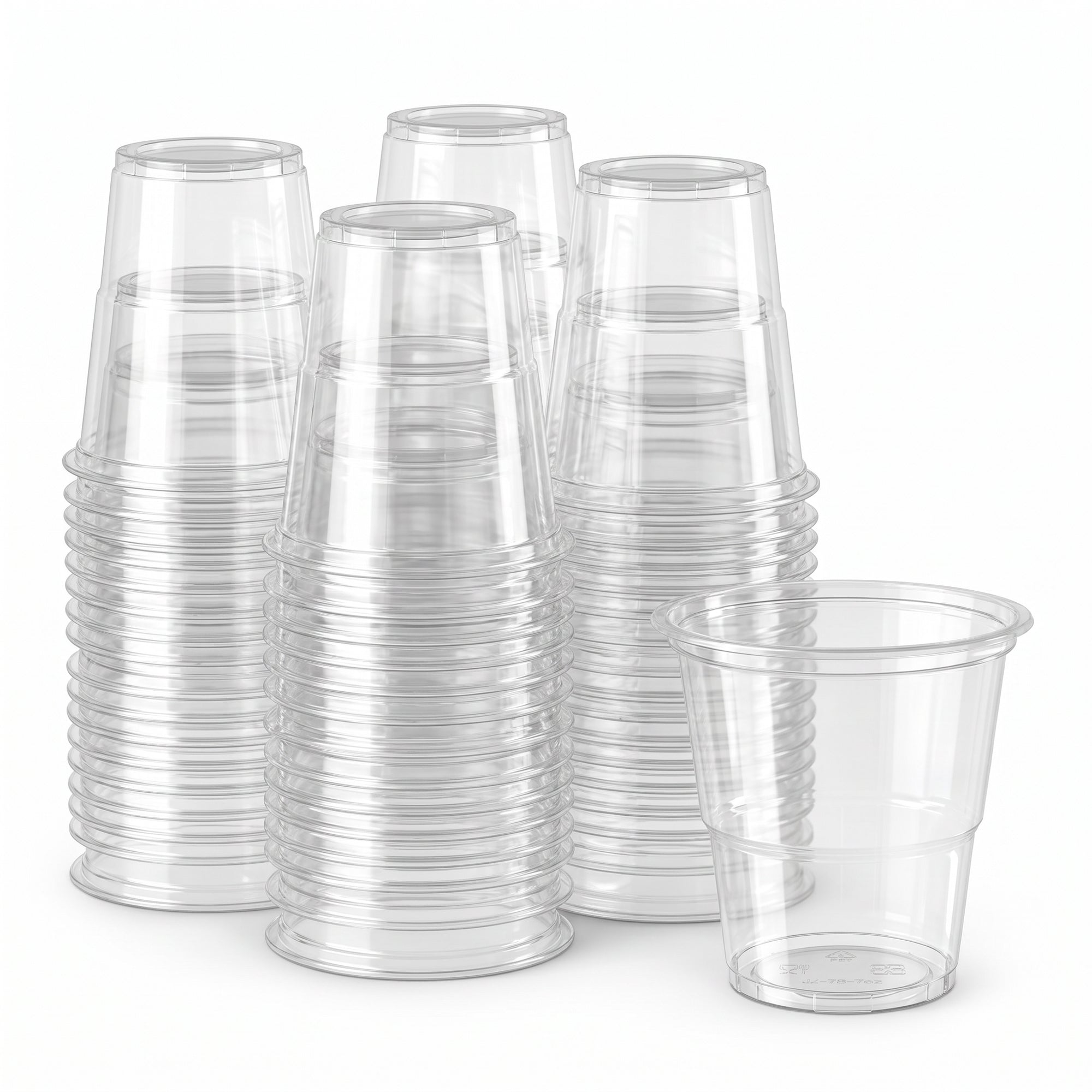 Stacks of clear plastic cups are neatly arranged against a white background. One cup stands upright, showcasing its transparent, smooth surface.