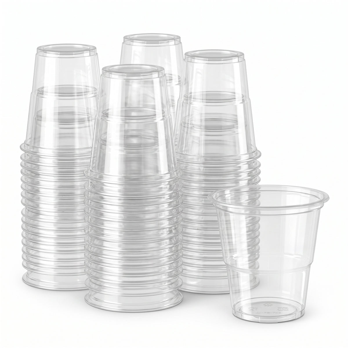 Stacks of clear plastic cups are neatly arranged against a white background. One cup stands upright, showcasing its transparent, smooth surface.