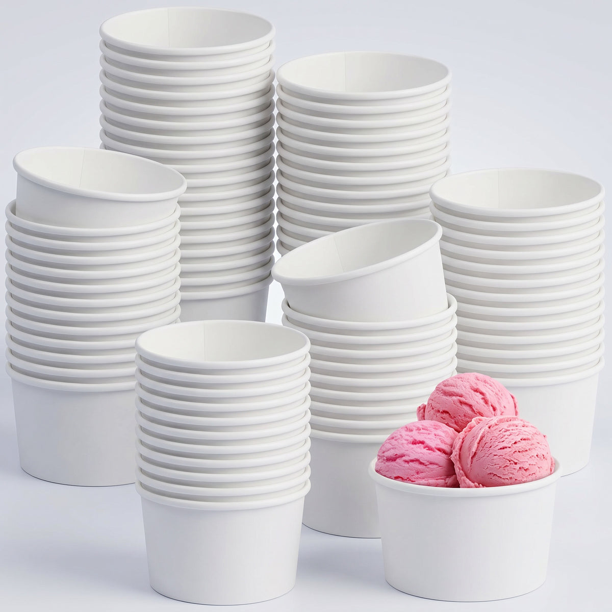 Stacks of white, empty ice cream cups are arranged with one cup holding two scoops of bright pink ice cream, creating a playful contrast.