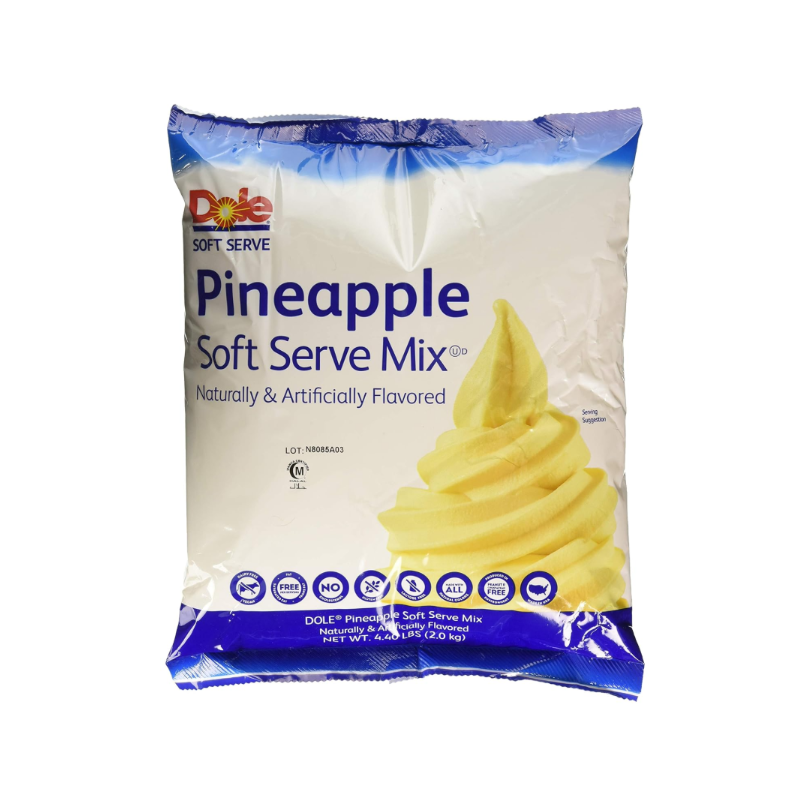 Swirl of creamy pineapple soft serve in a cone, topped with sprinkles and fruit pieces, with packaging in the background—highlighting its smooth texture and tropical flavour, ideal for pairing or customising with toppings.