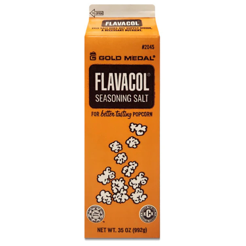 Orange carton of Flavacol seasoning salt for popcorn, decorated with illustrated popcorn kernels. Branding details are in black and white.