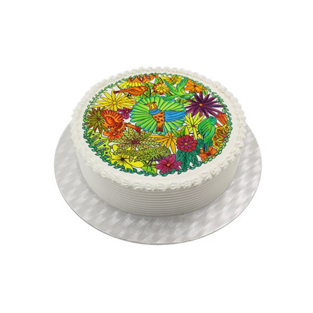 Round cake with white frosting and a colorful edible decoration on top, depicting vibrant flowers and leaves, creating a lively, festive look.