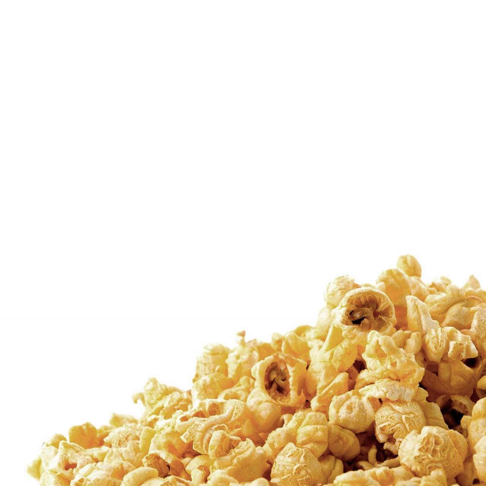 Close-up of a heap of buttery, freshly popped popcorn on a white background.