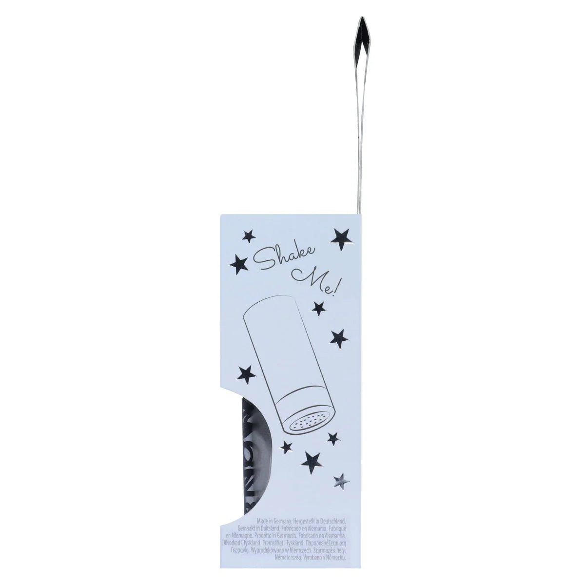 A Shake Me! cosmetic product in its original packaging, featuring a silver spatula applicator with a black tip and a light blue card sleeve decorated with black stars and the product name.