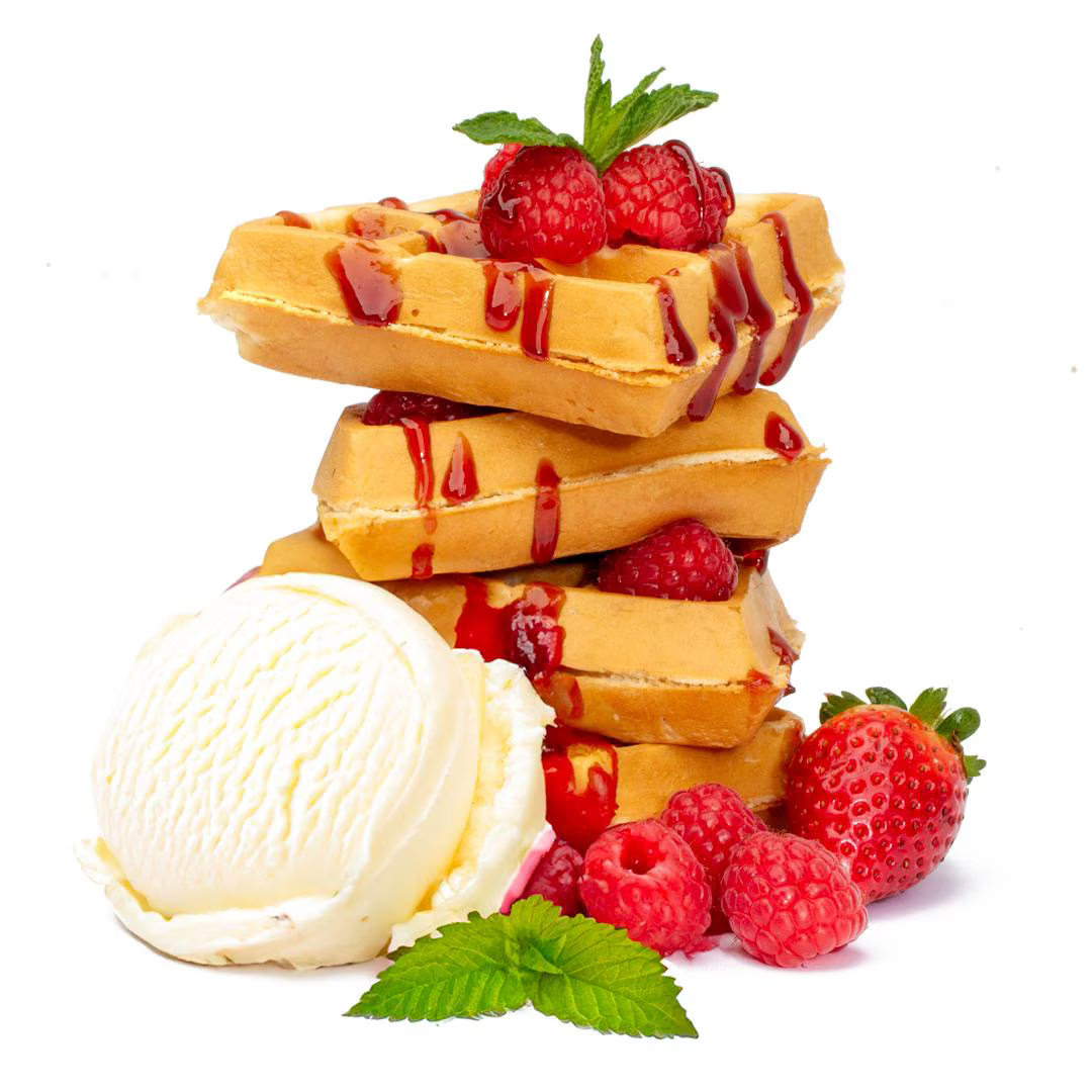 A stack of crisp, golden waffles topped with fresh strawberries, raspberries, and drizzled with raspberry syrup. A scoop of vanilla ice cream sits beside the waffles, with a mint leaf garnish.