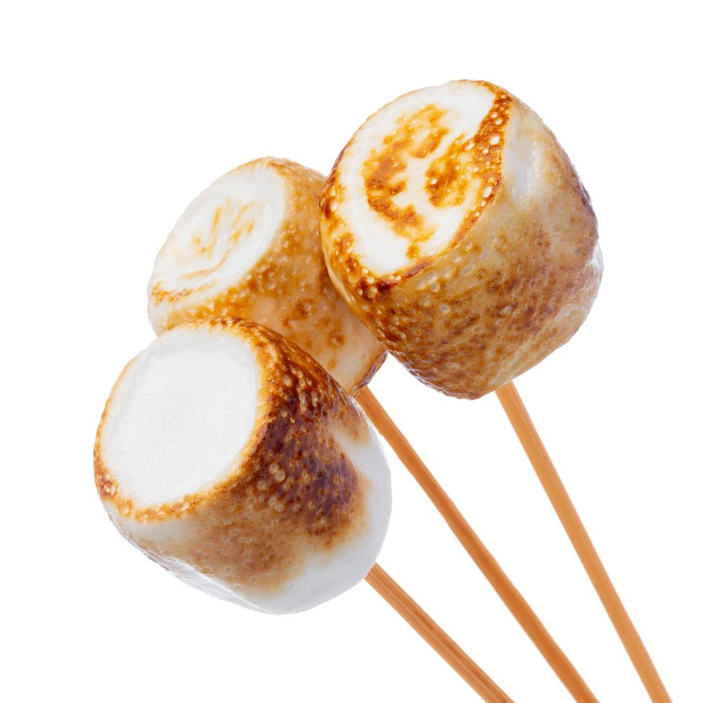 Toasted marshmallows on skewers: Three toasted marshmallows on wooden skewers, golden brown and slightly charred on the edges.