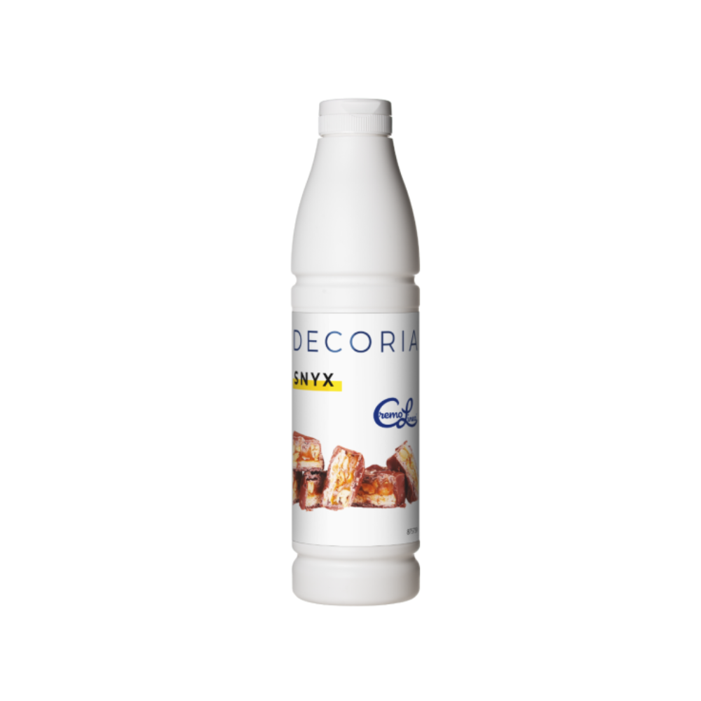 White bottle labeled "DECORIA SNYX" with images of caramel-coated pastries. The label includes a logo and branding, conveying a sweet treat theme.