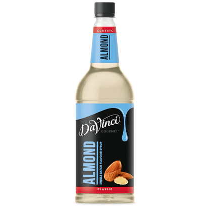 A bottle of DaVinci Gourmet Almond syrup, featuring a black and blue label with images of almonds.